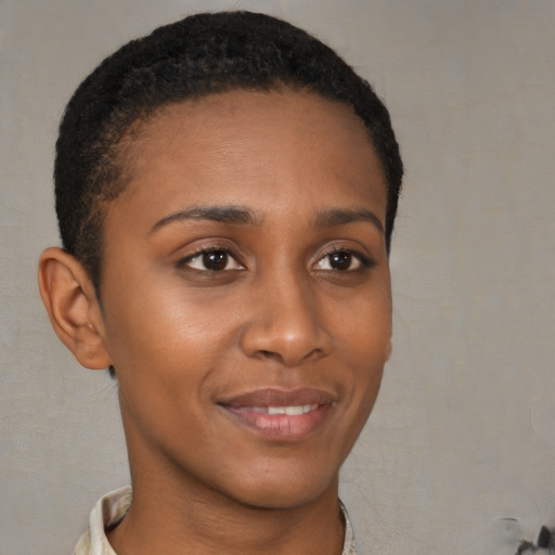 Joyful black young-adult female with short  brown hair and brown eyes