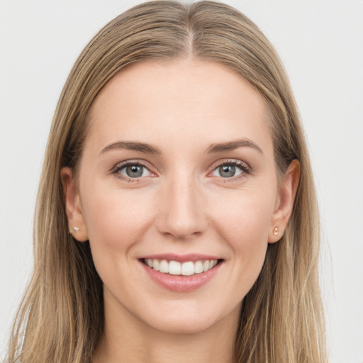 Joyful white young-adult female with long  brown hair and grey eyes