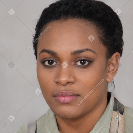 Joyful black young-adult female with short  black hair and brown eyes