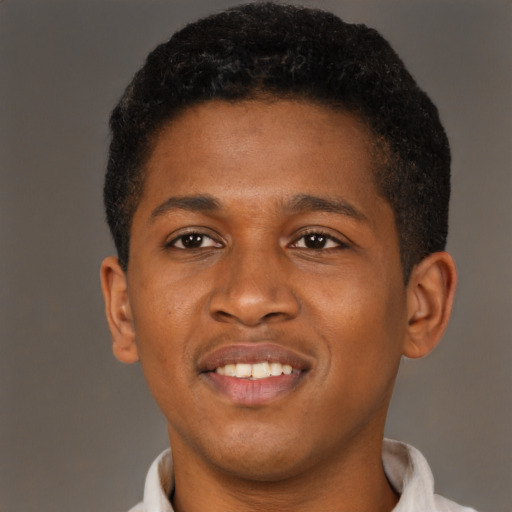 Joyful black young-adult male with short  brown hair and brown eyes