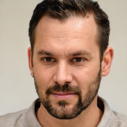 Joyful white adult male with short  brown hair and brown eyes