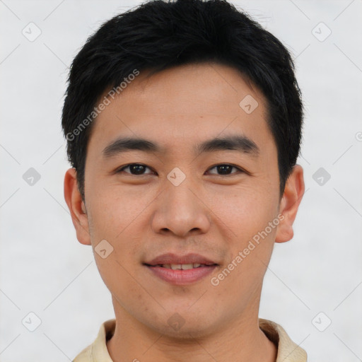 Joyful asian young-adult male with short  black hair and brown eyes