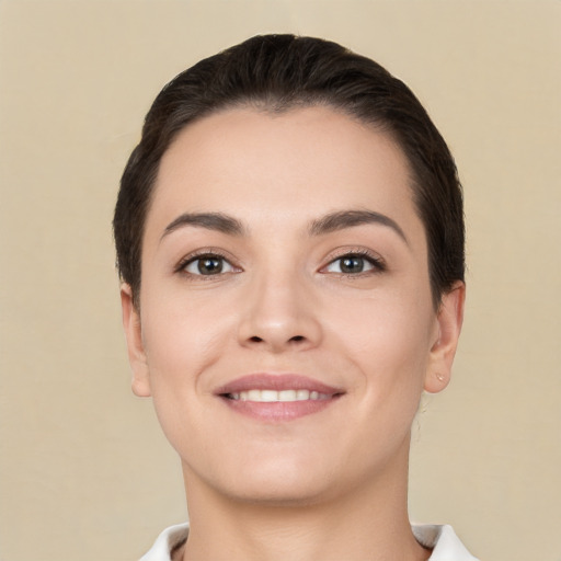 Joyful white young-adult female with short  brown hair and brown eyes