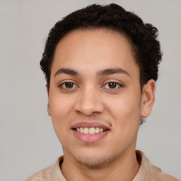 Joyful latino young-adult male with short  brown hair and brown eyes