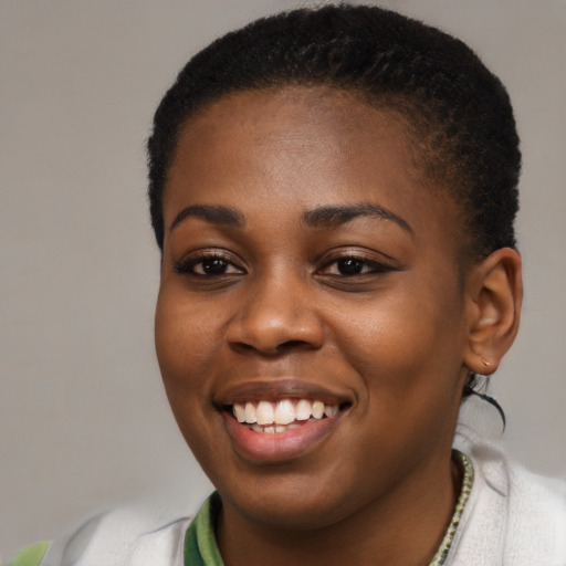 Joyful black young-adult female with short  black hair and brown eyes