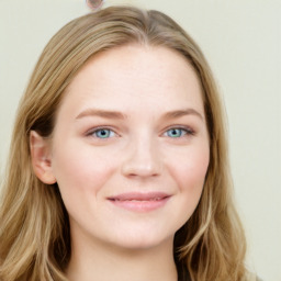 Joyful white young-adult female with long  brown hair and blue eyes