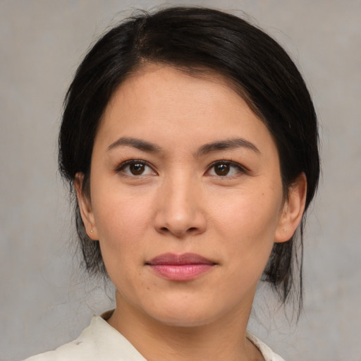 Joyful asian young-adult female with medium  brown hair and brown eyes