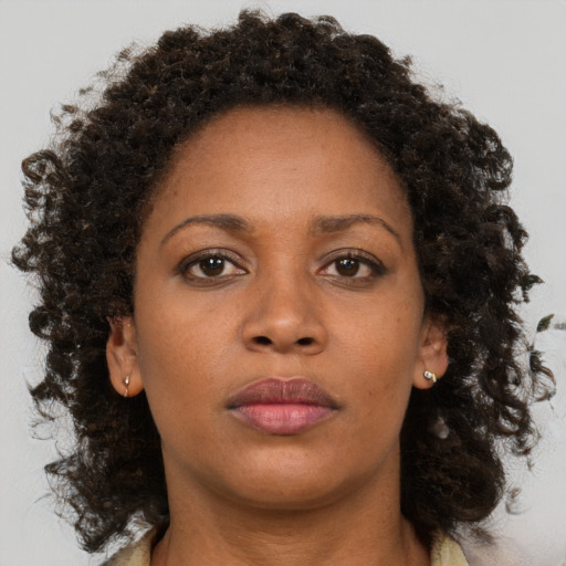 Neutral black adult female with medium  brown hair and brown eyes