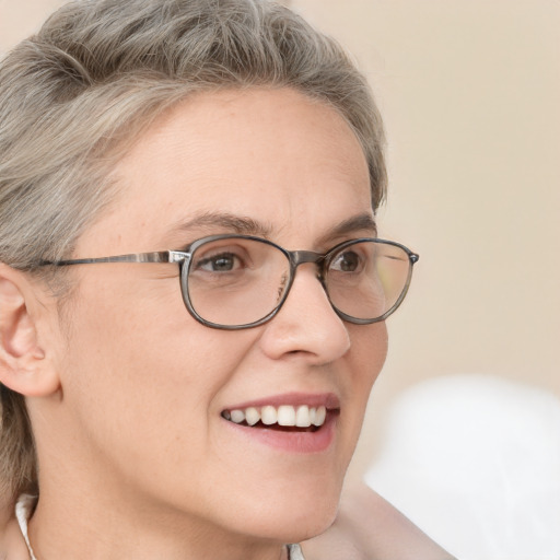 Joyful white adult female with medium  brown hair and grey eyes