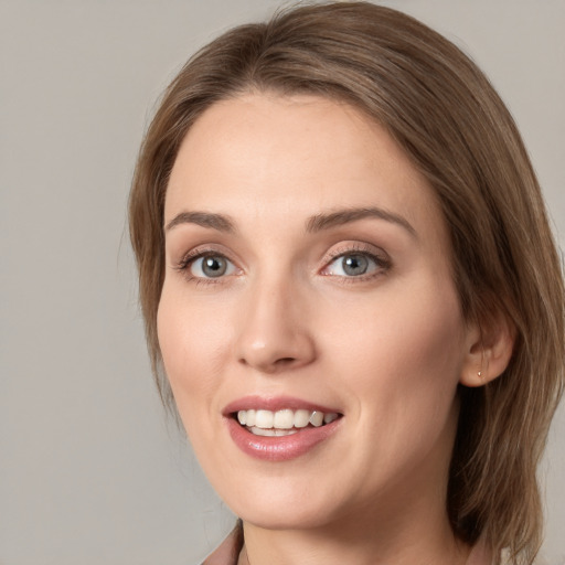 Joyful white young-adult female with medium  brown hair and grey eyes