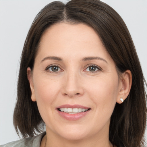 Joyful white adult female with medium  brown hair and brown eyes