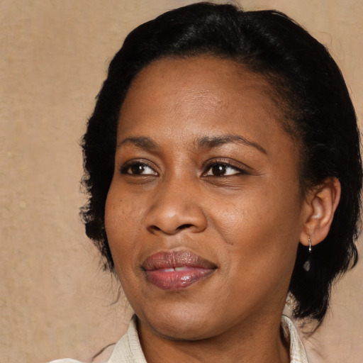 Joyful black adult female with medium  black hair and brown eyes
