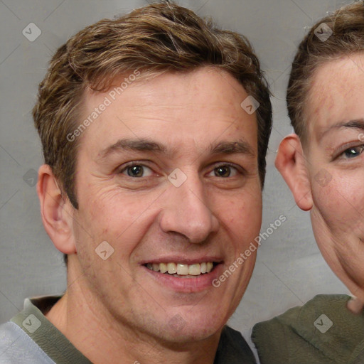 Joyful white adult male with short  brown hair and grey eyes