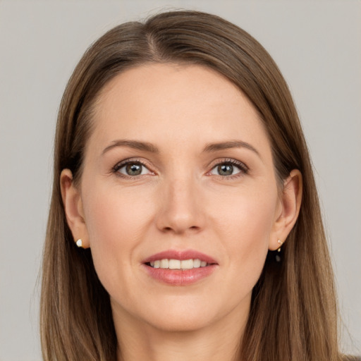 Joyful white young-adult female with long  brown hair and grey eyes