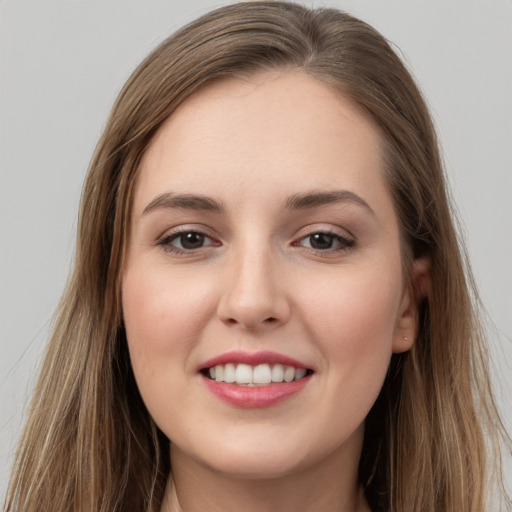 Joyful white young-adult female with long  brown hair and grey eyes