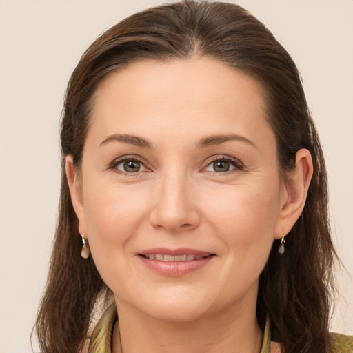 Joyful white young-adult female with medium  brown hair and brown eyes