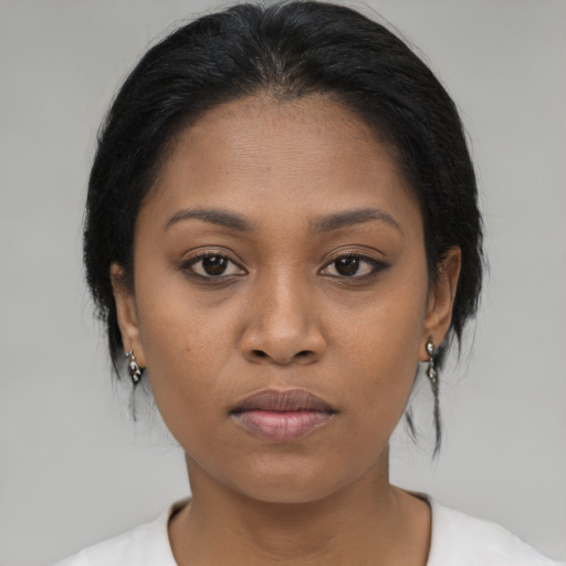 Joyful latino young-adult female with medium  brown hair and brown eyes