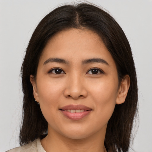 Joyful white young-adult female with medium  brown hair and brown eyes