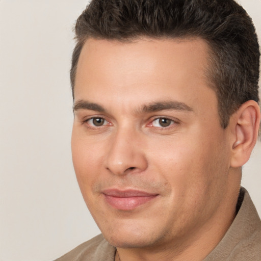 Joyful white young-adult male with short  brown hair and brown eyes