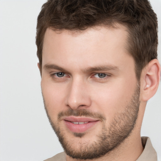 Joyful white young-adult male with short  brown hair and brown eyes