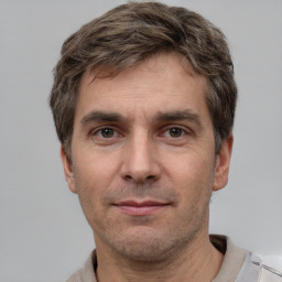 Joyful white adult male with short  brown hair and grey eyes