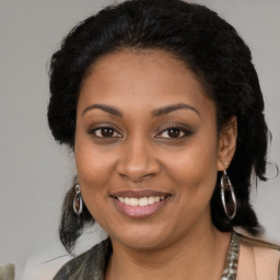 Joyful black young-adult female with medium  brown hair and brown eyes