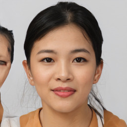 Joyful asian young-adult female with medium  black hair and brown eyes