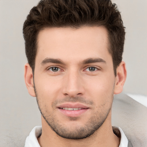 Joyful white young-adult male with short  brown hair and brown eyes