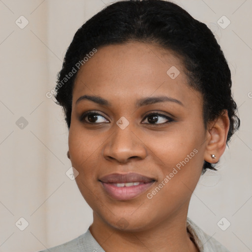 Joyful black young-adult female with short  black hair and brown eyes