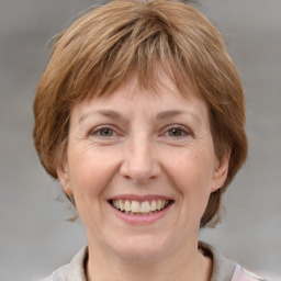 Joyful white adult female with medium  brown hair and grey eyes