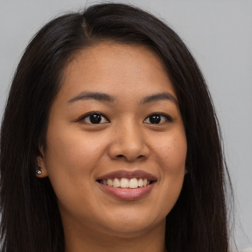 Joyful asian young-adult female with long  brown hair and brown eyes