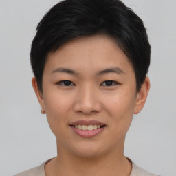 Joyful asian young-adult female with short  black hair and brown eyes