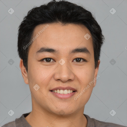 Joyful asian young-adult male with short  black hair and brown eyes