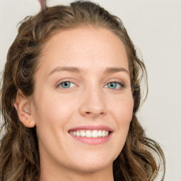 Joyful white young-adult female with long  brown hair and green eyes