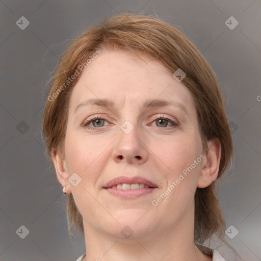 Joyful white adult female with medium  brown hair and grey eyes