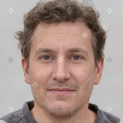 Joyful white adult male with short  brown hair and grey eyes