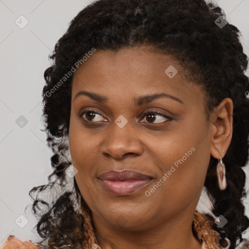 Joyful black young-adult female with medium  brown hair and brown eyes