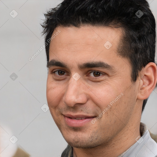 Joyful white young-adult male with short  black hair and brown eyes