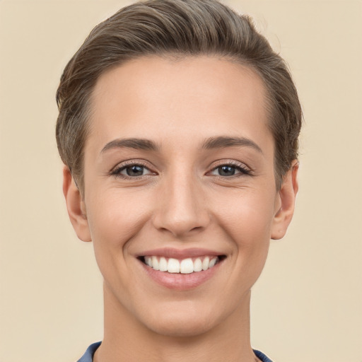 Joyful white young-adult female with short  brown hair and grey eyes