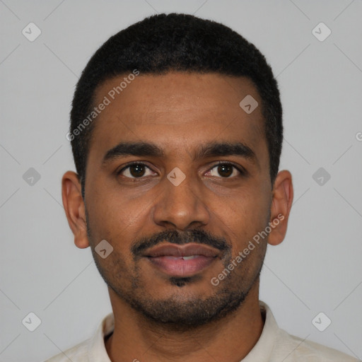 Joyful black young-adult male with short  black hair and brown eyes