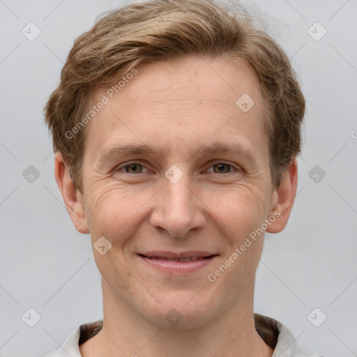 Joyful white adult male with short  brown hair and grey eyes