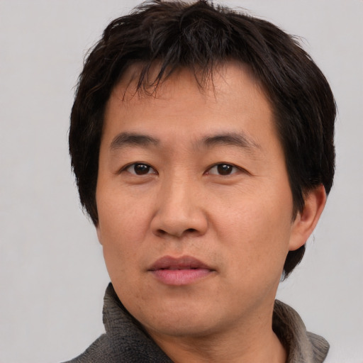 Neutral asian adult male with short  brown hair and brown eyes