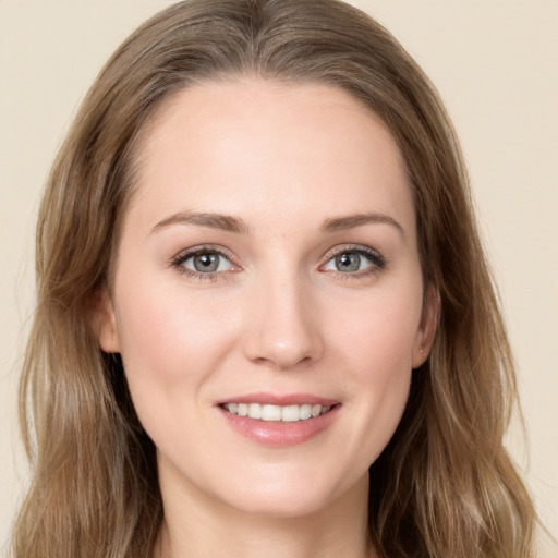 Joyful white young-adult female with long  brown hair and grey eyes