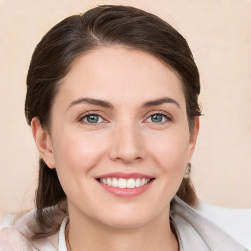 Joyful white young-adult female with medium  brown hair and brown eyes