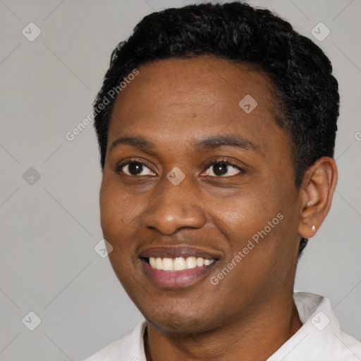 Joyful black young-adult male with short  black hair and brown eyes