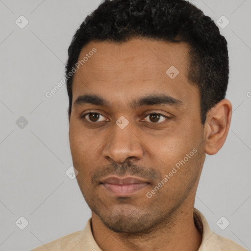 Joyful black young-adult male with short  black hair and brown eyes