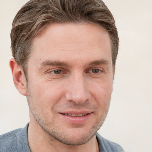 Joyful white adult male with short  brown hair and grey eyes