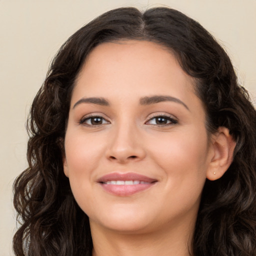 Joyful white young-adult female with long  brown hair and brown eyes