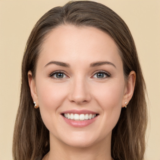 Joyful white young-adult female with long  brown hair and grey eyes