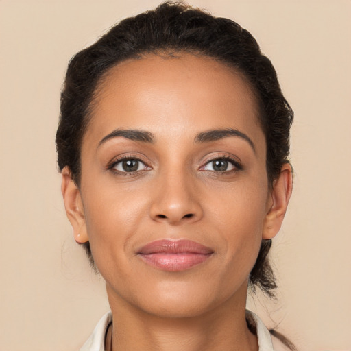 Joyful latino young-adult female with short  brown hair and brown eyes